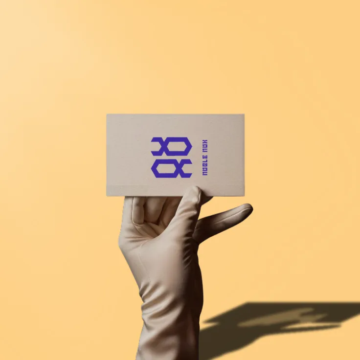 NobleNox business card held in a gloved hand